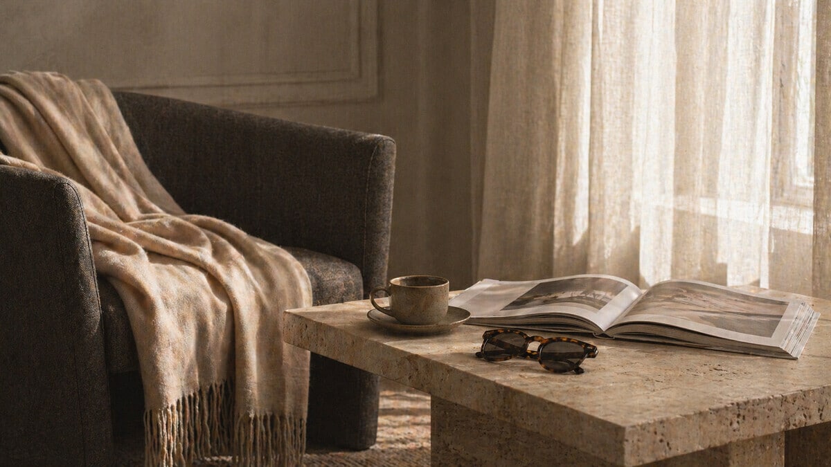 Intentional Living shown through an elegant morning routine with coffee art magazine soft textures and refined home styling